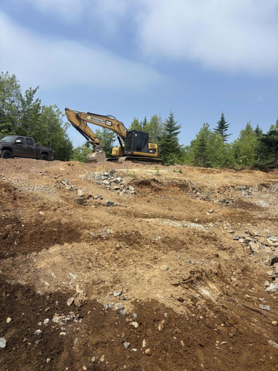 Excavating rock on the hillside site