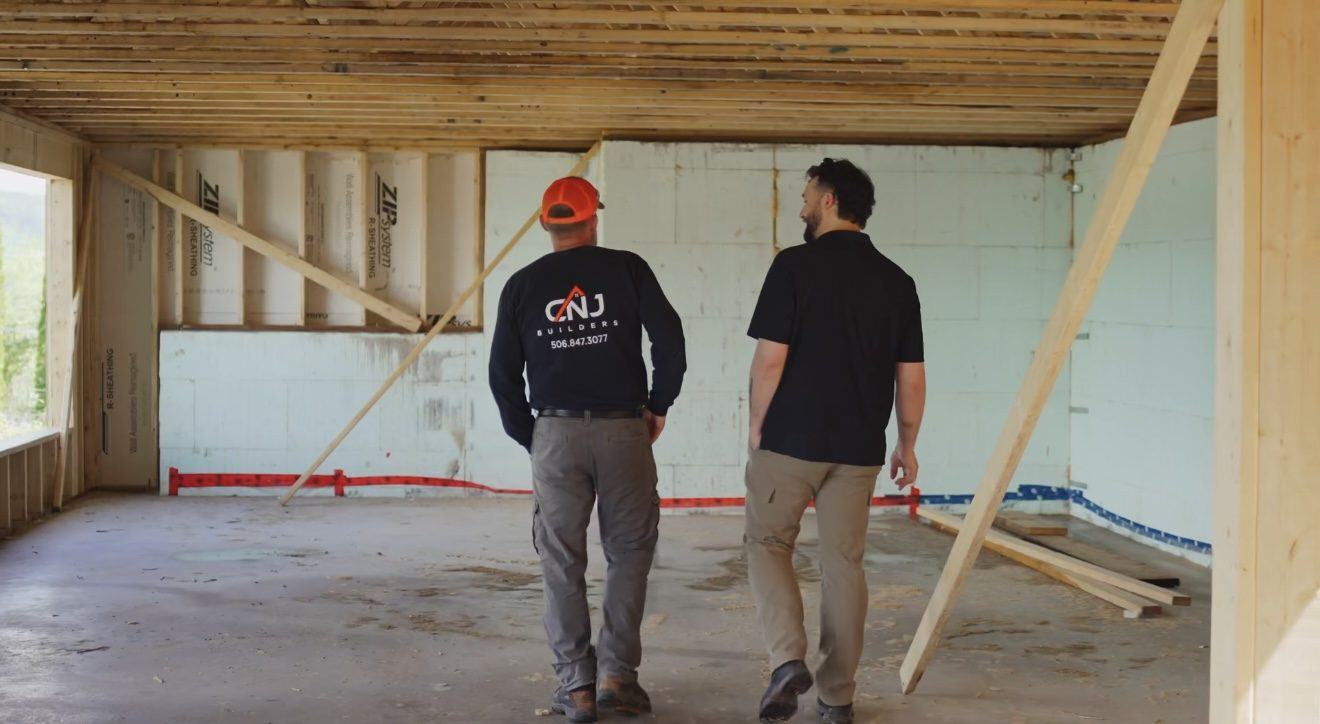 Chris Jeffries, left, and Nic Jeffries, right, walking through a home under construction