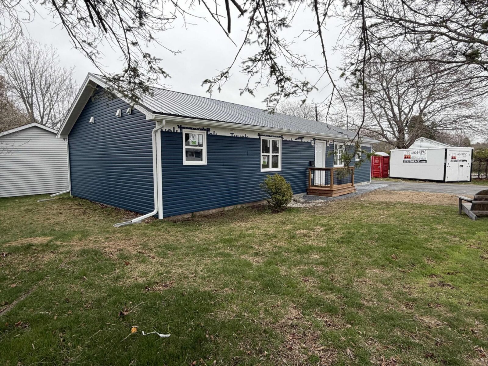Finished exterior with new blue siding