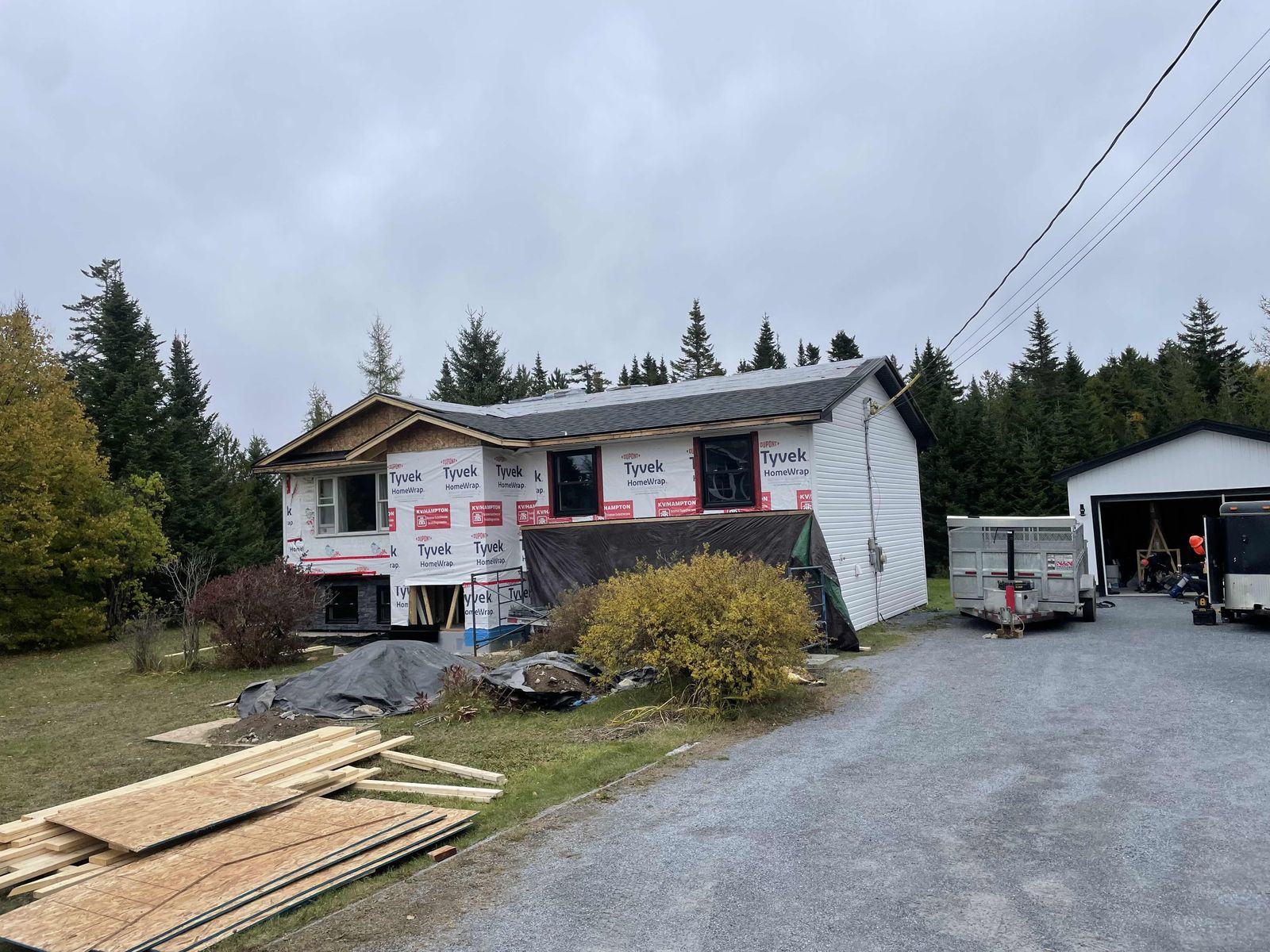 The house wrapped, with the new garage beside it
