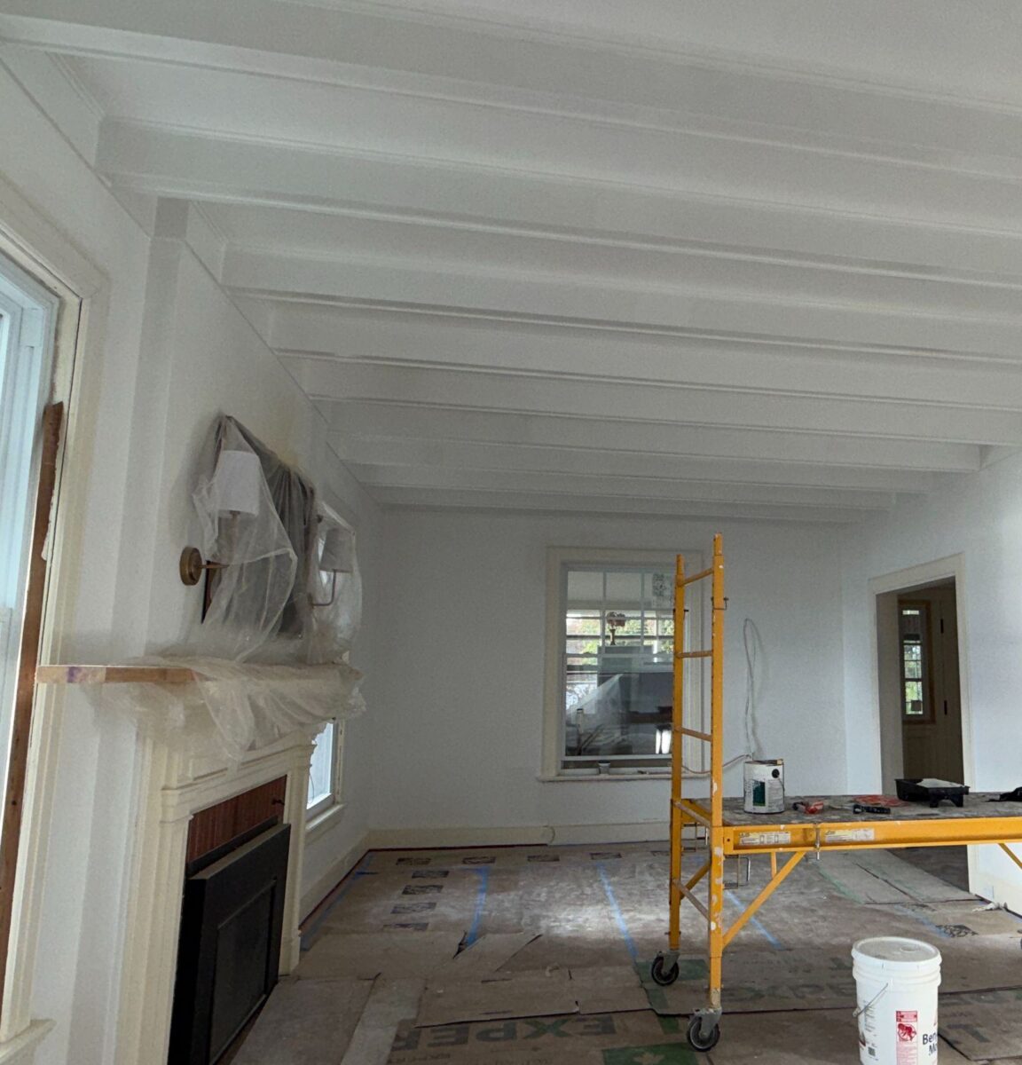 Living room with original fireplace during renovation