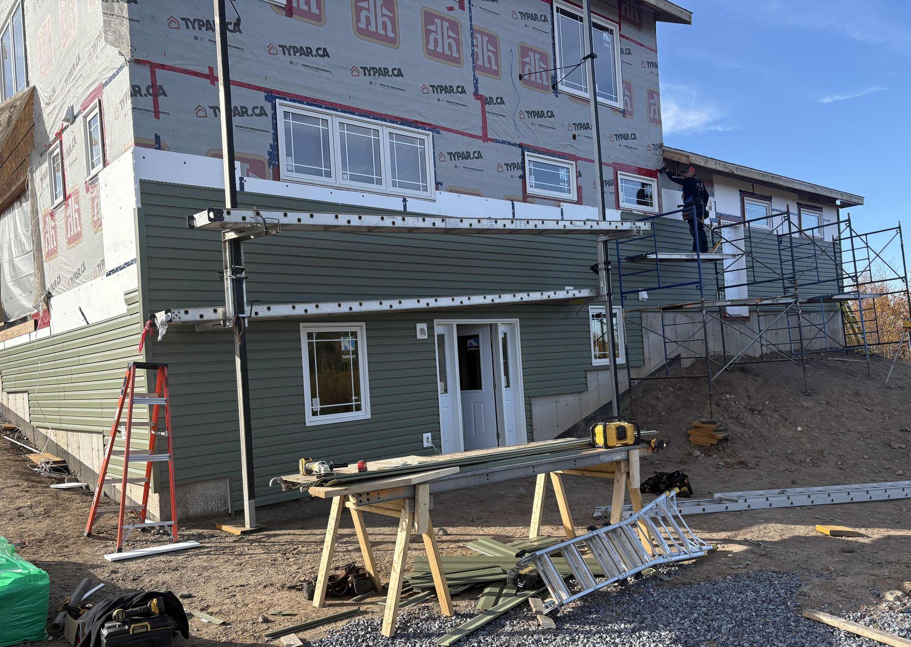 New home under construction with siding going on
